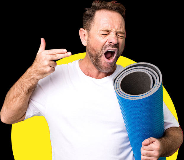Man holding yoga matt while yawning